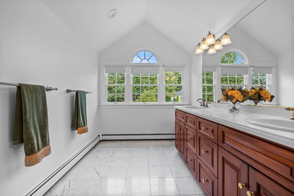 15 Stafford Road Lynnfield, MA 01940 - Photo 24 of 39 a bathroom with a sink and a large mirror next to a window