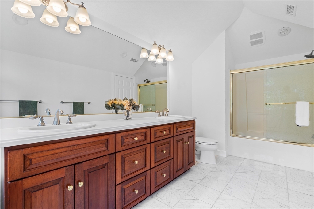 15 Stafford Road Lynnfield, MA 01940 - Photo 25 of 39 a spacious bathroom with a granite countertop sink a toilet a mirror and shower
