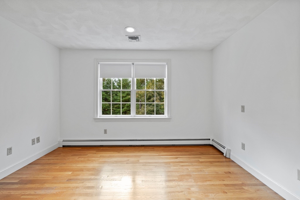 15 Stafford Road Lynnfield, MA 01940 - Photo 27 of 39 a view of an empty room with wooden floor and a window