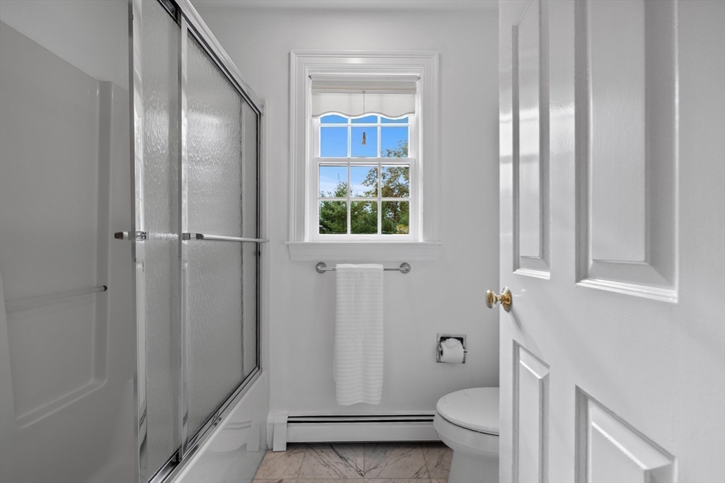 15 Stafford Road Lynnfield, MA 01940 - Photo 28 of 39 a bathroom with a granite countertop toilet a sink and a mirror