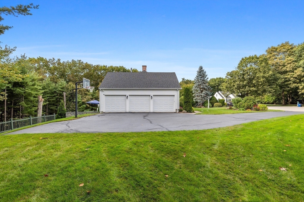 15 Stafford Road Lynnfield, MA 01940 - Photo 37 of 39 a view of a yard with a house in the background