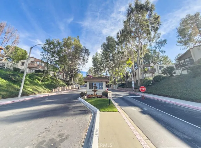a view of a house with a yard and tree s