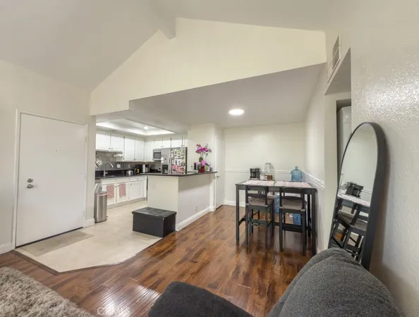 a living room with furniture a dining table and kitchen view