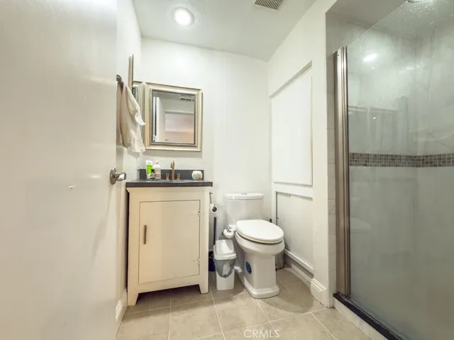 a white toilet sitting next to a bathroom sink