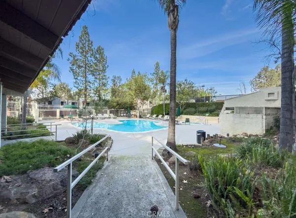 a view of a house with pool and yard