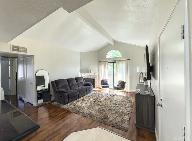 a living room with furniture windows and a flat screen tv