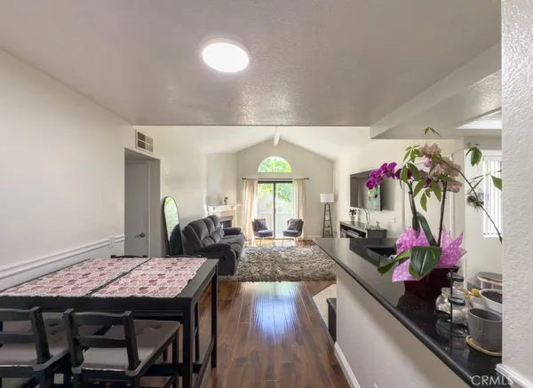 a view of a dining room with furniture and a potted plant