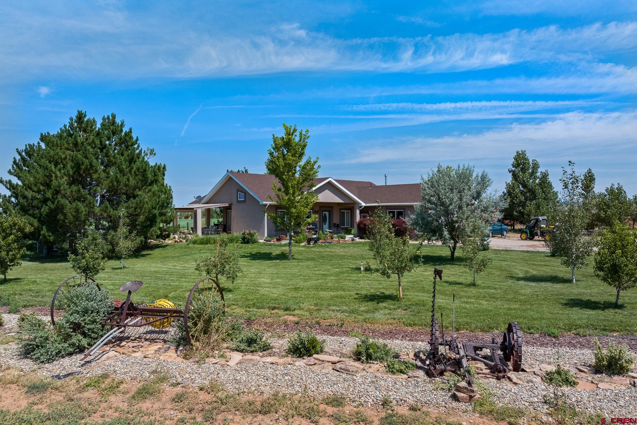 13723 Rd T Cahone, CO 81320 - Photo 27 of 36 a front view of a house with a yard