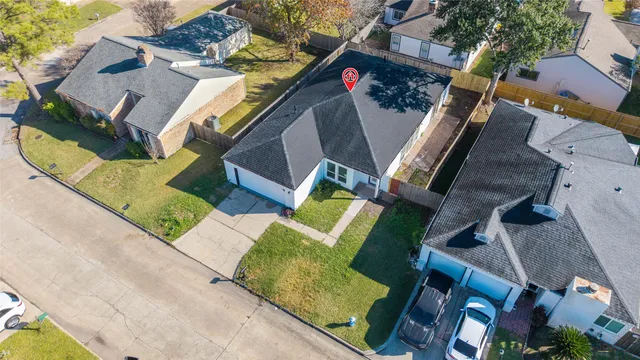 an aerial view of a house with a garden and entryway