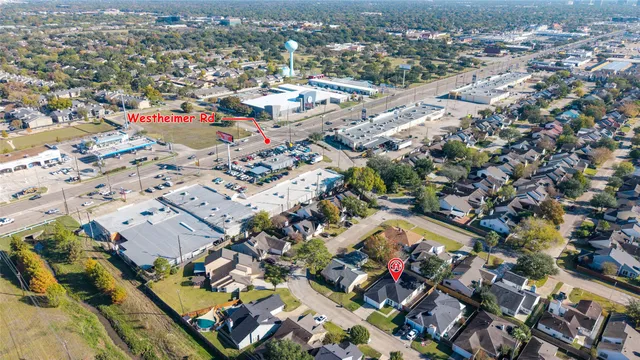 an aerial view of residential houses with city view