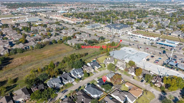 an aerial view of residential houses with outdoor space