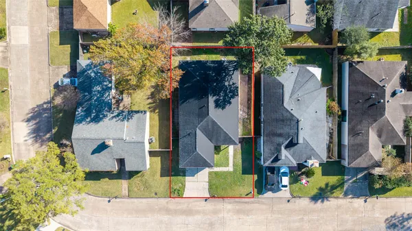 an aerial view of a house with a yard basket ball court and outdoor seating