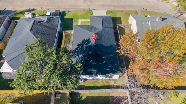 an aerial view of a house a yard and swimming pool