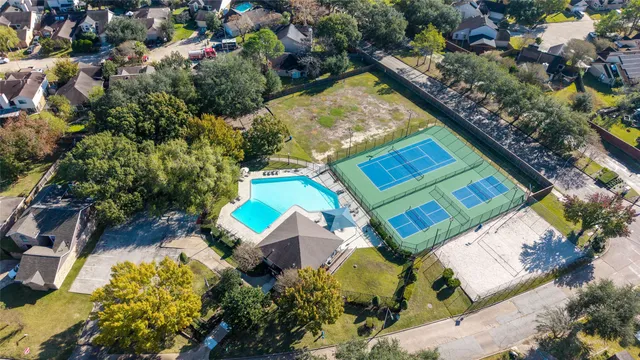 an aerial view of a house with a yard