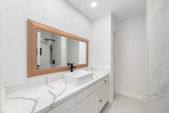 a bathroom with a sink and a mirror