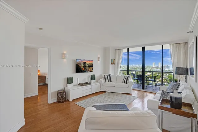 a living room with furniture and large windows