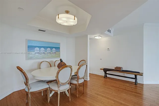 a dining room with furniture and wooden floor