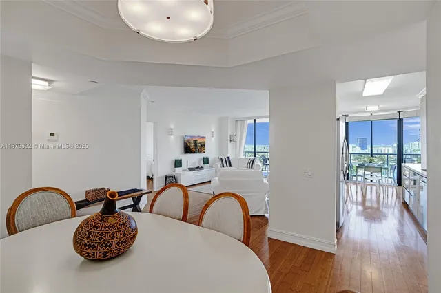 a view of a dining room with furniture wooden floor and chandelier