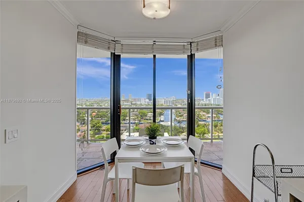 a view of a dining room with furniture window and wooden floor