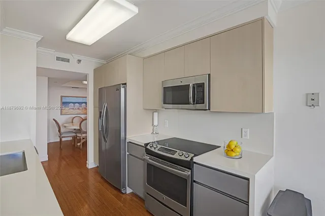 a kitchen with stainless steel appliances a stove microwave and a refrigerator