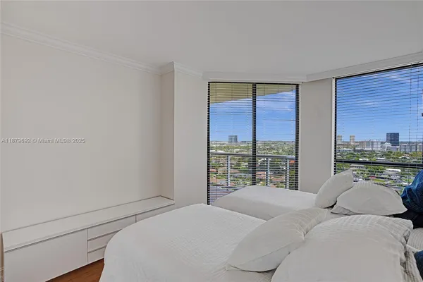a bedroom with a bed and a large window