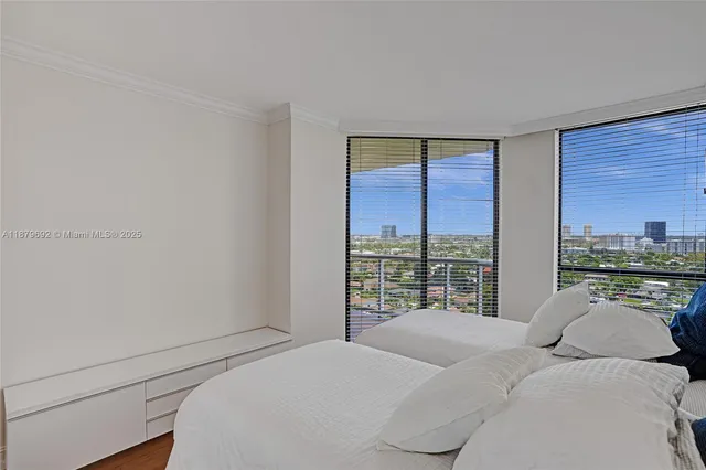 a bedroom with a bed and a large window