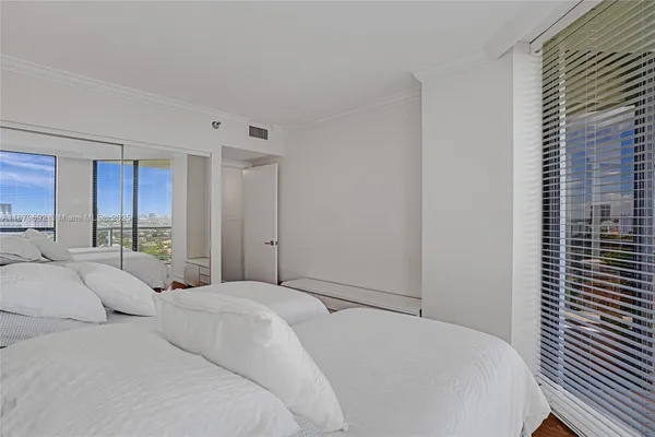 a bedroom with a large bed and a window