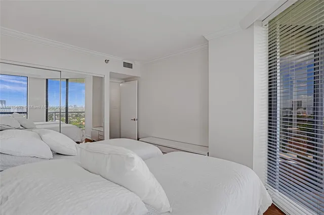 a bedroom with a large bed and a window