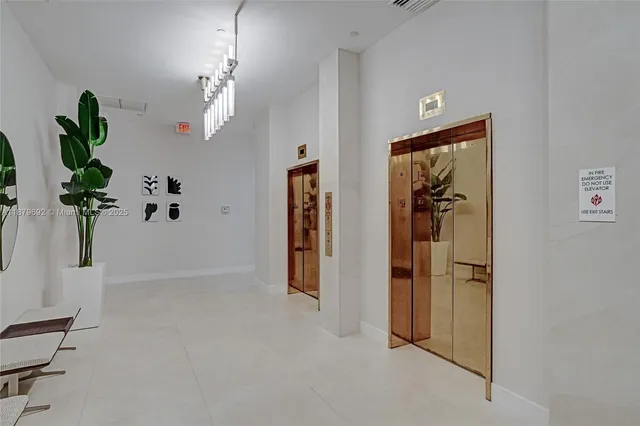 a lobby with furniture and a large mirror