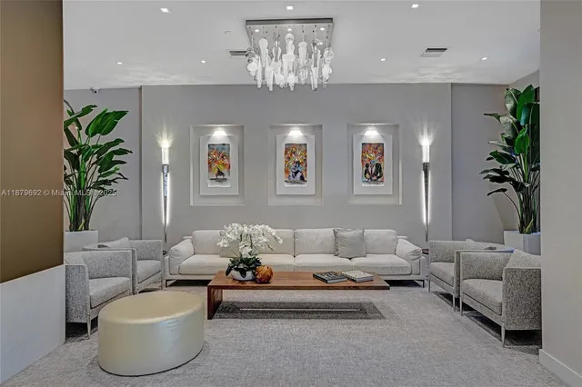 a living room with furniture and a chandelier
