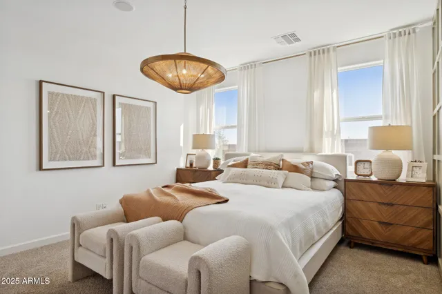 a bedroom with a bed and a potted plant