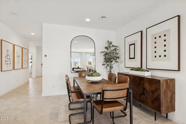 a kitchen with stainless steel appliances granite countertop a refrigerator a stove a sink a stove a dining table and chairs