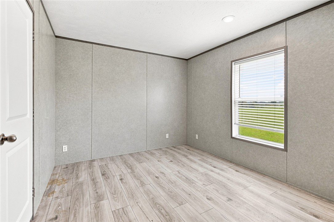 112 Purdy Road Iva, SC 29655 - Photo 20 of 33 Gleaming wood-look flooring and clean panel walls define this versatile secondary bedroom space.
