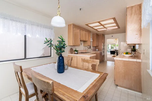 a kitchen with a table chairs and refrigerator