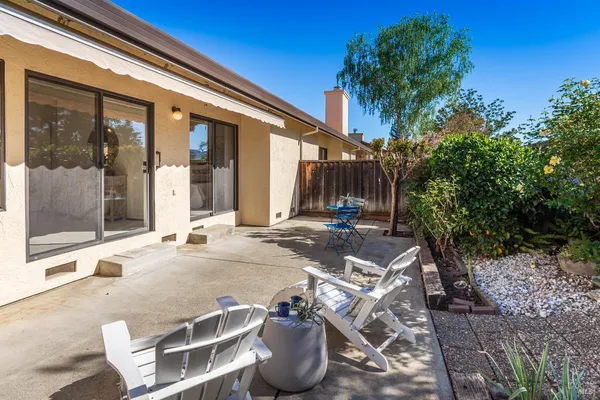 a view of a patio with table and chairs and potted plants