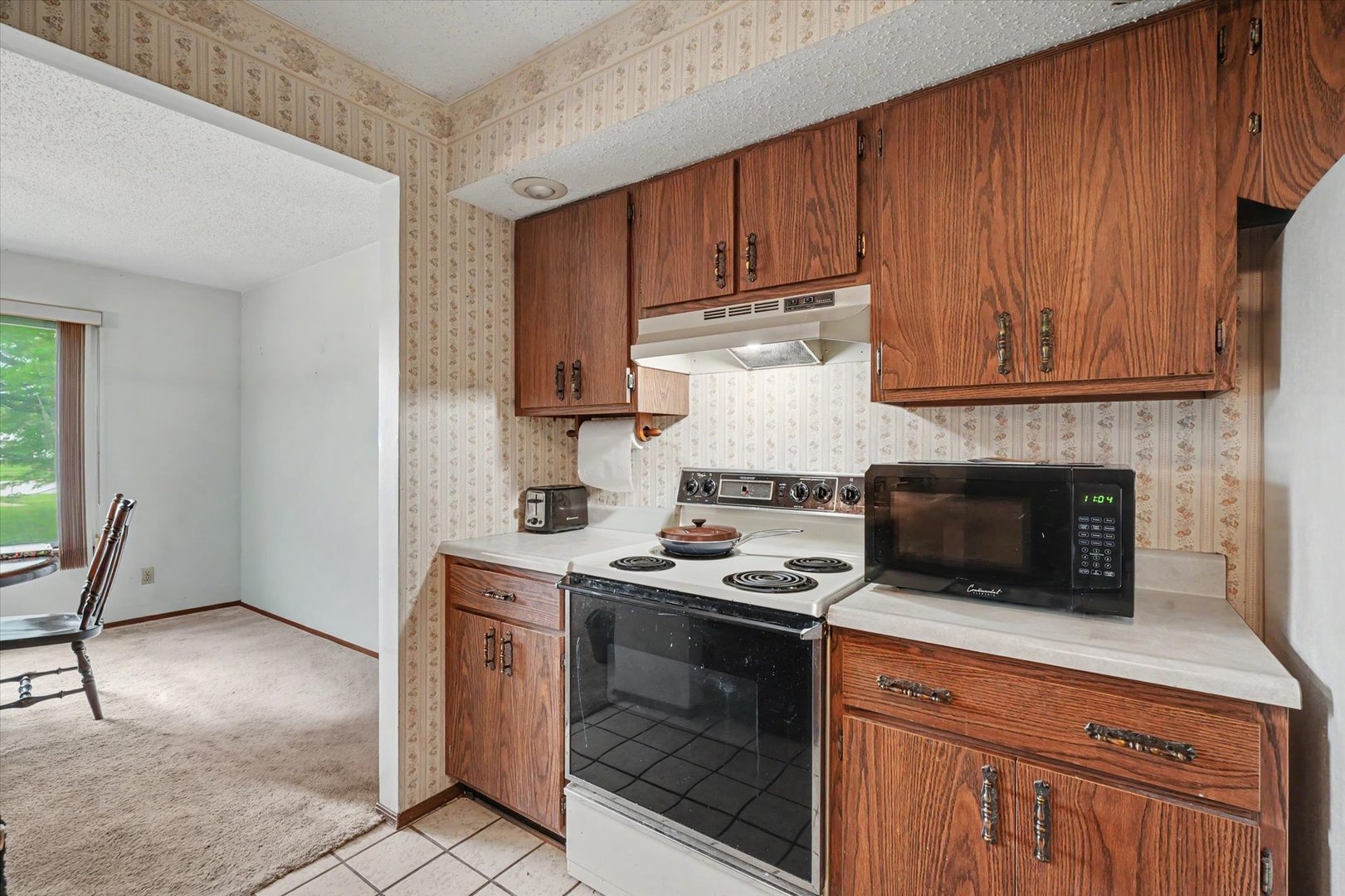 711 Higgins Road Champaign, IL 61822 - Photo 11 of 23 a kitchen with a stove and a microwave
