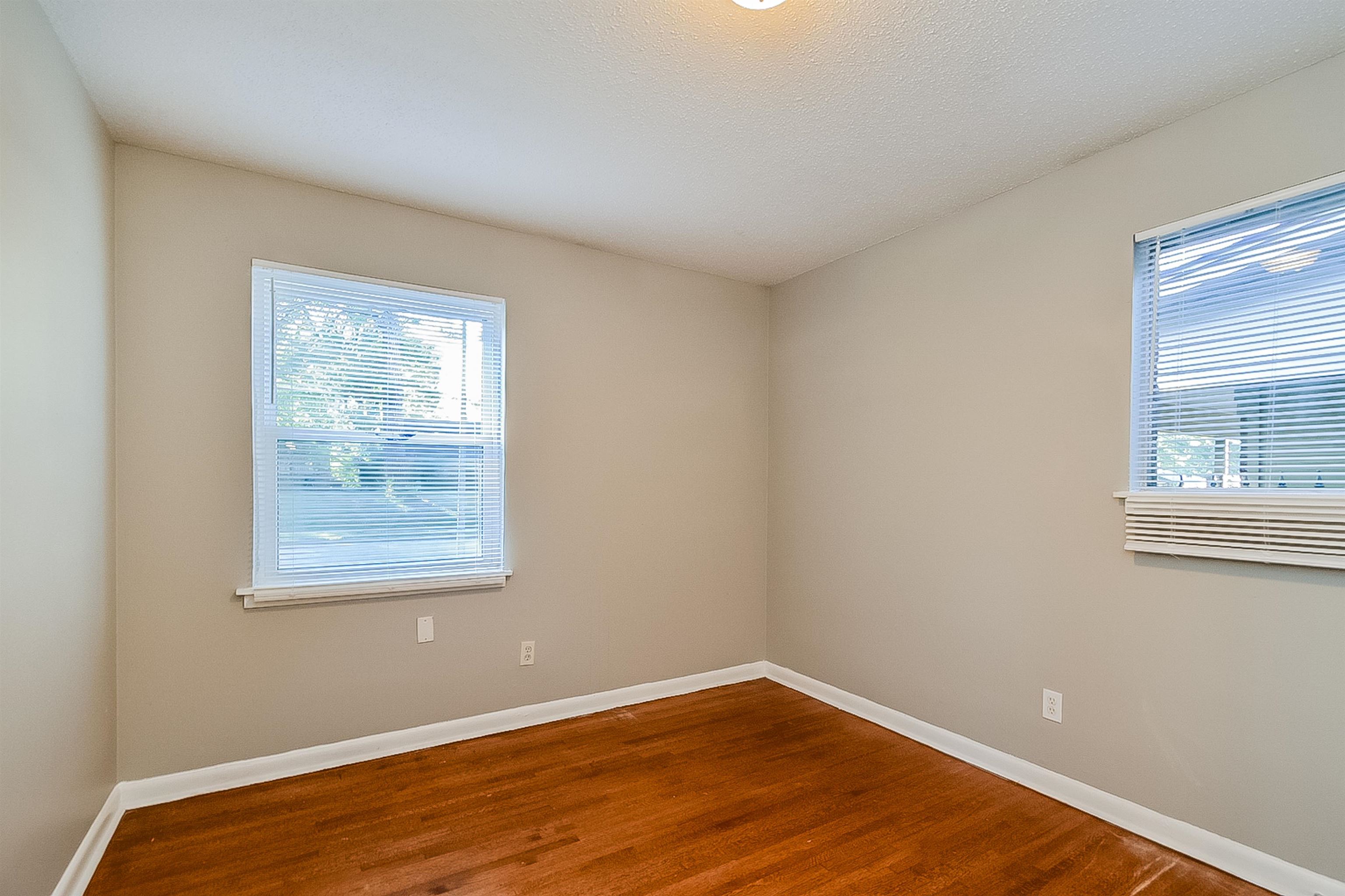3020 Capri Road Memphis, TN 38118 - Photo 9 of 14 Empty room featuring baseboards and dark wood-type flooring