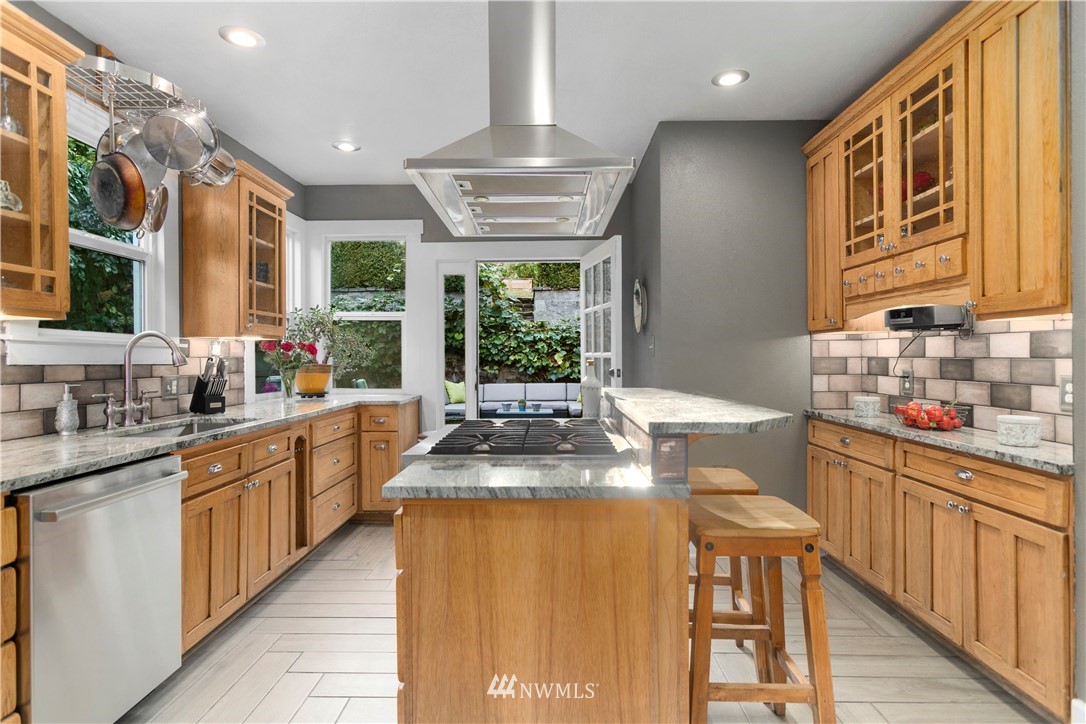 1625 27th Avenue Seattle, WA 98122 - Photo 13 of 40 a kitchen with stainless steel appliances granite countertop sink stove and cabinets