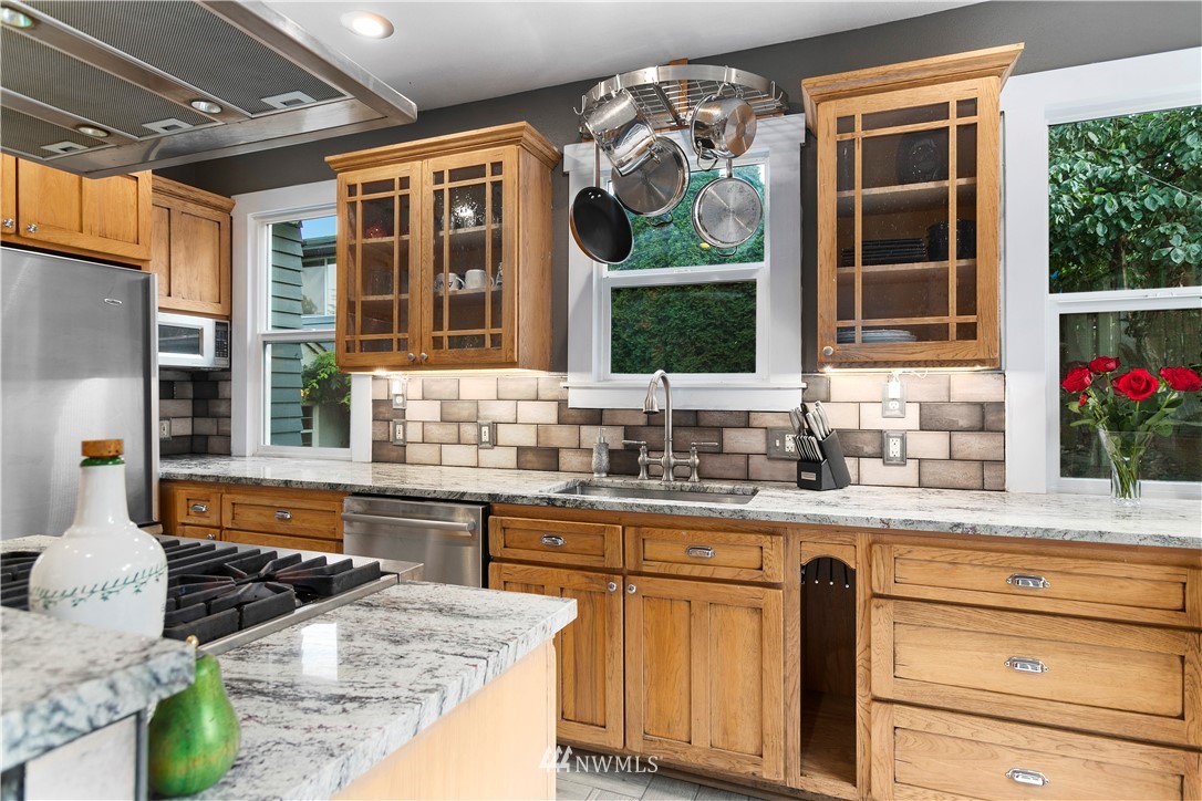 1625 27th Avenue Seattle, WA 98122 - Photo 15 of 40 a kitchen with granite countertop a sink and a stove