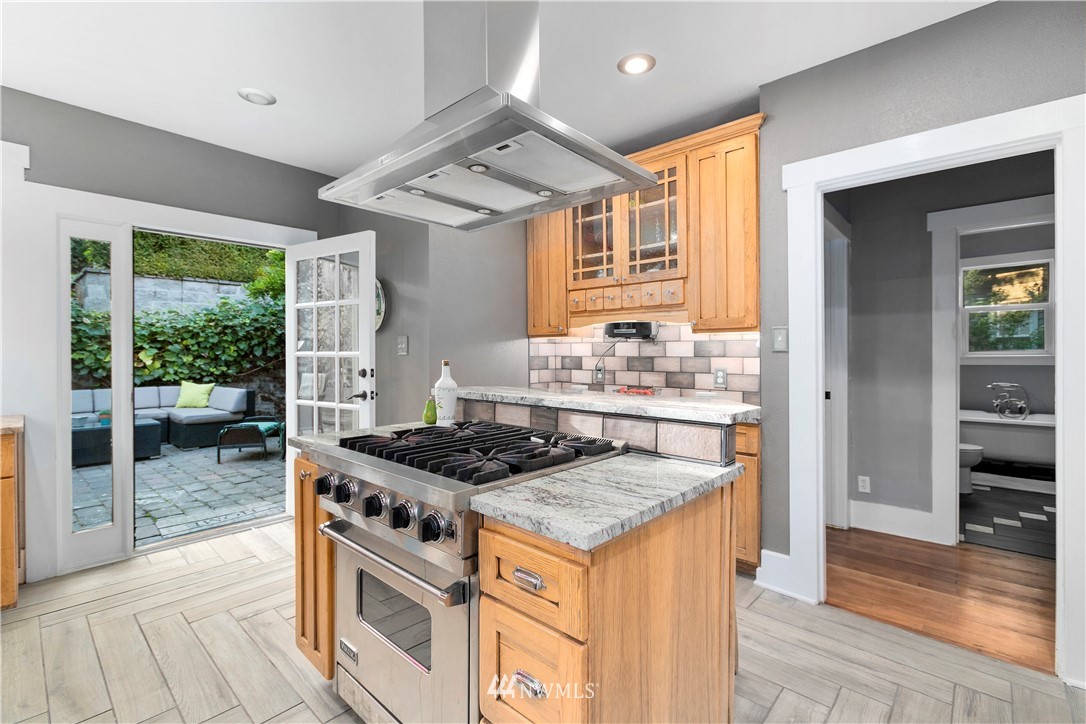 1625 27th Avenue Seattle, WA 98122 - Photo 16 of 40 a kitchen with stainless steel appliances granite countertop a stove and a sink