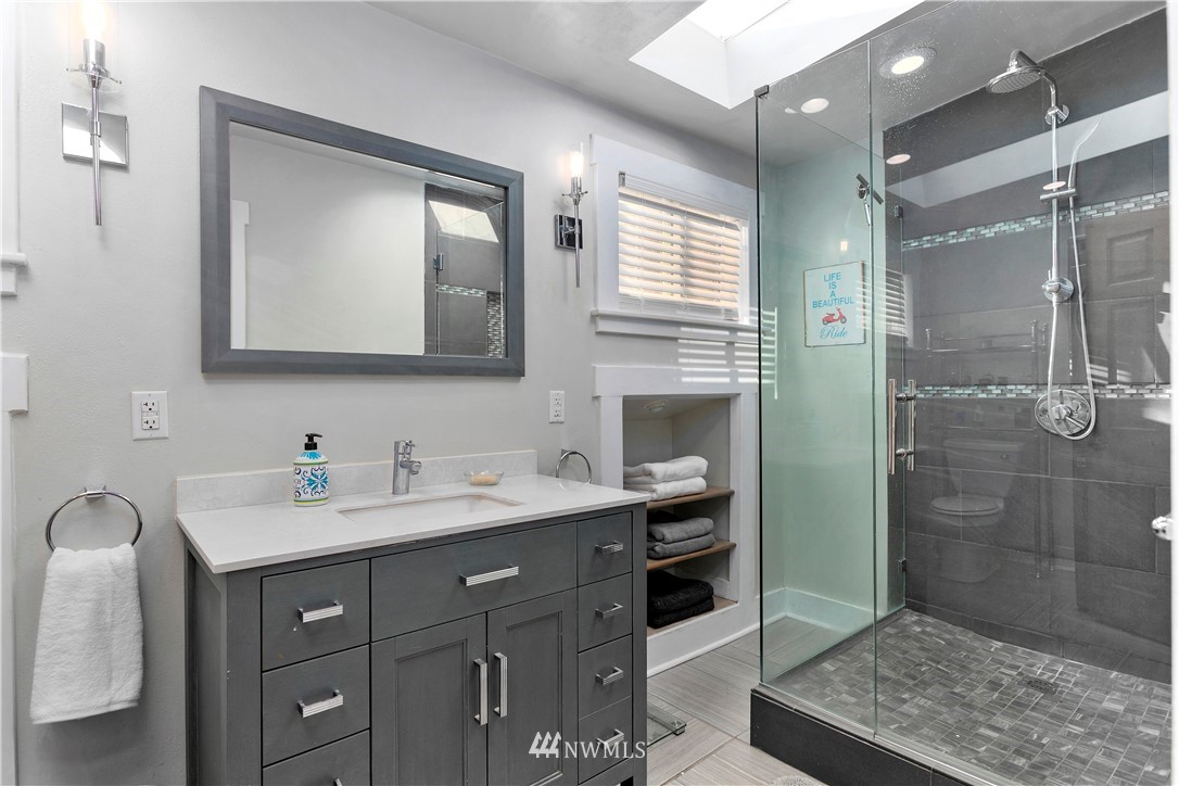 1625 27th Avenue Seattle, WA 98122 - Photo 20 of 40 a bathroom with a sink a vanity a mirror and shower