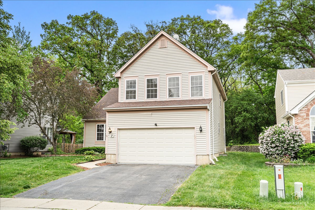 7 Eagle Court Streamwood, IL 60107 - Photo 2 of 31 a front view of a house with a yard and garage