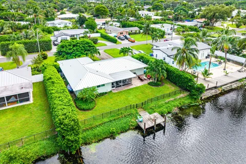 an aerial view of a house with garden space and street view