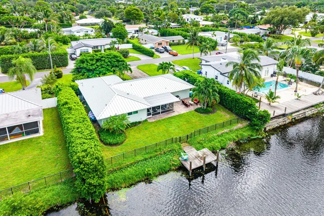 an aerial view of a house with garden space and street view
