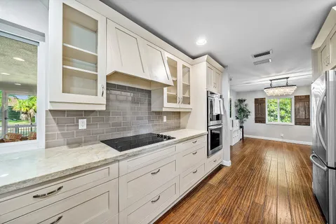 a kitchen with sink and cabinets