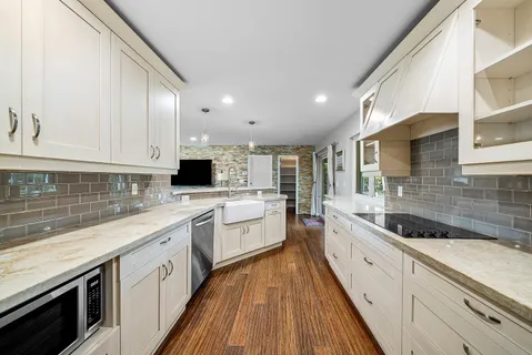 a large kitchen with a sink and cabinets