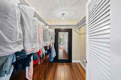 a view of a hallway with entryway wooden floor and front door
