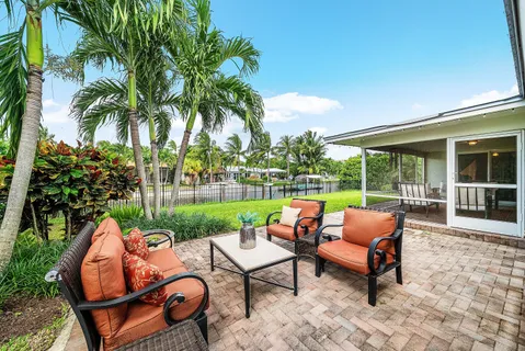 a view of a house with swimming pool and sitting area