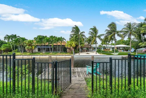 an aerial view of residential houses with outdoor space and swimming pool