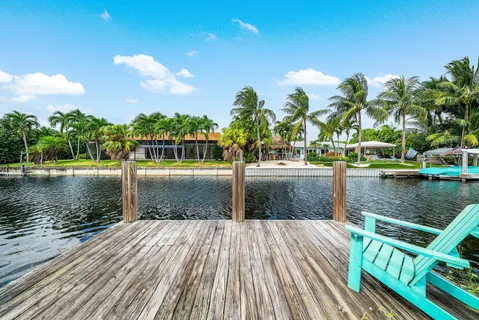an aerial view of a house with a yard and lake view